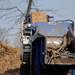 A wood chipper chops up logs by the side of Dexter-Pinckney Road on Thursday morning. Angela J. Cesere | AnnArbor.com
