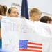 From left: 6th graders Kaylie LaPorte, Juliann Chis, Christian Diaz and Caden Keider hold up a banner thanking veterans for their service. Angela J. Cesere | AnnArbor.com
