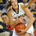 Ohio State guard Smantha Prahalis, left, reaches to try to take the ball from Michigan guard Nicole Elmblad. Angela J. Cesere | AnnArbor.com