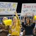 From left: 14-year-old South Lyon basketball teammates Sierra Suter, Sarah Stockford and Madison Swiatlowski hold up signs during the game. Angela J. Cesere | AnnArbor.com