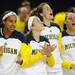 From left: Cyesha Goree, Nicole Elmblad, Kate Thompson and Sam Arnold cheer from the bench. Angela J. Cesere | AnnArbor.com