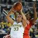 Ohio State guard Raven Ferguson, right, and center Darryce Moore, left, try to block a shot by Michigan guard Carmen Reynolds. Angela J. Cesere | AnnArbor.com