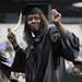 Washtenaw Community College graduate Crystal Anderson dances to "Ain't No Stopping Us Now", played by WCC's Top 40 Combo and Jazz Orchestra during the WCC commencement ceremony at the Eastern Michigan University Convocation Center on Saturday morning.  Angela J. Cesere | AnnArbor.com