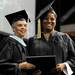  Washtenaw Community College board of trustees vice chair Diana McKnight-Morton, left, hands her daughter, Lynoa McKnight, her diploma after graduation during the WCC commencement ceremony held at Eastern Michigan University's Convocation Center on Saturday morning. Angela J. Cesere | AnnArbor.com