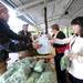 Tantre Farm employee Gary Mazzeo hands a bag to Ann Arbor resident Jennifer Chudy to put her greens in at the Ann Arbor Farmers Market. Angela J. Cesere | AnnArbor.com