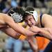 Pioneer's Keegan Pape, right, tries to gain the advantage of Michigan Center's Cody Konieczki during the 125 lb weight class match. Angela J. Cesere