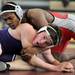 Pioneer's Leon Sunstein, left, tries to get out from under Michigan Center's Nate Poole during the 171 lb weight class match. Angela J. Cesere