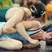 Skyline's JAcob Coulson, bottom, tries to get out from underneath Lumen Christi's Jean Leigh during the 140 lb weight class match. Angela J. Cesere