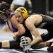 Hamilton's Collin Welcher, right, tries to force down Greenville's Mike Schmidt during the 103 lb weight class quarter final match at the Palace of Auburn Hills during the MHSAA individual wrestling finals. Angela J. Cesere | AnnArbor.com
