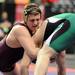 Manchester's Austin Hamilton, left, tries to force down Sand Creek's Garrett Miller during the Div. 4, 215 lb weight class match at the MHSAA individual wrestling finals at the Palace of Auburn Hills. Angela J. Cesere | AnnArbor.com