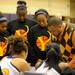 Ypsilanti head coach Chris Slater, right, talks to his team at the end of the first quarter. Angela J. Cesere