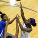 Ypsilanti Lincoln's Arielle Cagor, left, and Dominique Foley, center, try to block a shot by Ypsilanti's Jasmine Jones. Angela J. Cesere