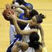 Ypsilanti's Cara Easley, second from bottom, grabs a rebound. Angela J. Cesere