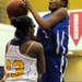 Ypsilanti's Chasidy Chambers, left, tries to block a shot by Ypsilanti Lincoln's Dominique Foley. Angela J. Cesere