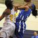 Ypsilanti's NyRee Watson, left, tries to block a shot by Ypsilanti Lincoln's Asia Youngblood. Angela J. Cesere