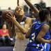 Ypsilanti Lincoln's Jaslynn Rollins, right, tries to block a shot by Ypsilanti's Cara Easley. Angela J. Cesere