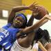 Ypsilanti's Heather Rowley, right, grabs the ball from Ypsilanti Lincoln's Asia Youngblood, fouling her in the process. Angela J. Cesere