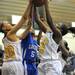 Ypsilanti's Tori Amison, left, and Carneysha McGee, right, fight Ypsilanti Lincoln's Arielle Cagor, center, for a rebound. Angela J. Cesere