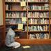 University of Michigan Director of the Residential College Angela Dillard arranges books in the library in the newly renovated East Quad dormitory. Melanie Maxwell | AnnArbor.com