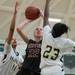 Dexter's Kathryn Pisano jumps to make a shot as Huron's Sara Golidy and Alexis Garner try to block her.
Courtney Sacco I AnnArbor.com 