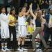 Wolverines Head coach Kim Barnes Arico high fives her team as the are up 70-69 with possession of the ball and seconds left in the game.
Courtney Sacco I AnnAarbor.com 
