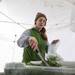 Chelsey Jordan from Garden Works bags ups some greens for a customer on a snowy Saturday morning at the Ann Arbor Farmers Market. Garden Works offers greens year-round. 
 Courtney Sacco I AnnArbor.com 