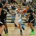 Skyline's Janae Sims dives the ball past Huron's Payton Sims and Micah Robinson during the first half of their game at Skyline High School Tuesday night.
Courtney Sacco I AnnArbor.com  