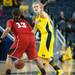 Wolverines Jenny Ryan yells to one of her team mates as she is guarded by Cornhuskers Brandi Jeffery during the first half of their game Thursday night.
Courtney Sacco I AnnArbor.com 
