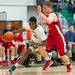 Huron's Xavier Cochran drives the ball down court past Bedford's Adam Swisher during first half of their game Thursday evening at Huron High School.
Courtney Sacco I AnnArbor.com 