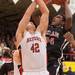 Nick Percins jumps as he tries to make a basket as Temperance Bedford's Jeremy Hams blocks his shot during the first half of the district final game at Temperance Bedford high school Friday Mar. 8th.
Courtney Sacco I AnnArbor.com 