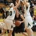 Heritage's Sydney Vondette and Allie Miller guard Dexter's Teia McGahey during first half of the state quarterfinals game at Davison High School Tuesday, Mar. 13th.
Courtney Sacco I AnnArbor.com  