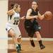 Dexter's Makenzie Svihra drives the bull up court as Heritage's Aubree Snow guards her during first half of the state quarterfinals game at Davison High School Tuesday, Mar. 13th.
Courtney Sacco I AnnArbor.com  