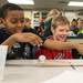 Joshua Gina and Elijah Kenworthy perform an experiment to test the density of a group of objects during a trip to Washtenaw Community College a group of forth-graders form Willow Run Community Schools March 20. Courtney Sacco I AnnArbor.com   