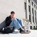 University of Michigan senior Andrew Curran reads a book outside of Angell Hall on Saturday, March 30.
Courtney Sacco I AnnArbor.com   