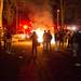 University of Michigan fans watch as debris burns in the middle of White Street in Ann Arbor after the Wolverines' loss to Louisville.
Courtney Sacco I AnnArbor.com