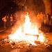 University of Michigan fans watch as debris burns in the middle of White Street in Ann Arbor after the Wolverines' loss to Louisville.
Courtney Sacco I AnnArbor.com