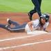 Wolverines freshmen Sierra Romero slides in to first after trying to seal second base during the bottom of the first inning of their game against Valparaiso Friday May 17.
Courtney Sacco I AnnArbor.com    