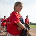 A player holds her hat over her heart as the National Anthem plays during Rec & Ed youth baseball's opening day at Veteran's Memorial Park.
Courtney Sacco I AnnArbor.com