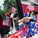 American flags waved out of a window as a car travels down Cross Street taking part in Ypsilanti's 4th of July parade.
Courtney Sacco I AnnArbor.com
