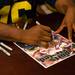 Marcus Ray former Wolverine and member of the 1997 national championship team, autographs a Sports Illustrated cover at the M Den on Wednesday, July, 10. 
Courtney Sacco I AnnArbor.com    