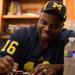Marcus Ray former Wolverine and member of the 1997 national championship team, sings an autograph at the M Den on Wednesday, July, 10. 
Courtney Sacco I AnnArbor.com    