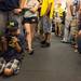 Eight-year-old Ethan Preston plays with a cell phone as he waits in line at the M Den for an autograph from former Michigan Wolverines Denard Robinson, Mike Martin, Jordan Kovacs and Marcus Ray on Wednesday, July 10. 
Courtney Sacco I AnnArbor.com    