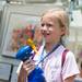 10-year-old Jessie Stahl uses a spray water fan to keep cool during the Ann Arbor Art Fair on Wednesday, July 17, 2013. 
Courtney Sacco I AnnArbor.com 