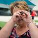 Roberta Jahn looks through a kaleidoscope made by Susan Goulding during the State Street Area Art Fair on Wednesday, July 17, 2013. 
Courtney Sacco I AnnArbor.com 