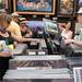 People look through prints fromm Scanlan Photography at Ann Arbor Art Fair on Wednesday, July 17, 2013. 
Courtney Sacco I AnnArbor.com