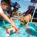 6-year-old Max Meri helps cool of Leila a 2 month old boxer labrador retriever during the "adopt-a-thon" held at Petco in Ann Arbor, Saturday, July 20.
Courtney Sacco I AnnArbor.com  