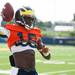 Michigan quarterback Devin Gardner throws a ball on the practice field outside of the Al Glick Field House on Thursday, August 8, 2013. 
Courtney Sacco I AnnArbor.com