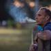 A man smokes a cigarette as he watches the tractor pull at the Chelsea Community Fair in Chelsea, Friday, August, 23.Courtney Sacco I AnnArbor.com  