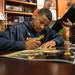 Former Wolverines basketball player Trey Burke signs an autograph at the MDen in Ann Arbor, Saturday, August, 24.
Courtney Sacco I AnnArbor.com   