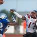 Belleville's quarterback Luke Edwards throws the ball under pressure form Lincoln's Troy Brumfield during the first quarter of their game at Lincoln High School, Friday, Aug, 30.
Courtney Sacco I AnnArbor.com    
